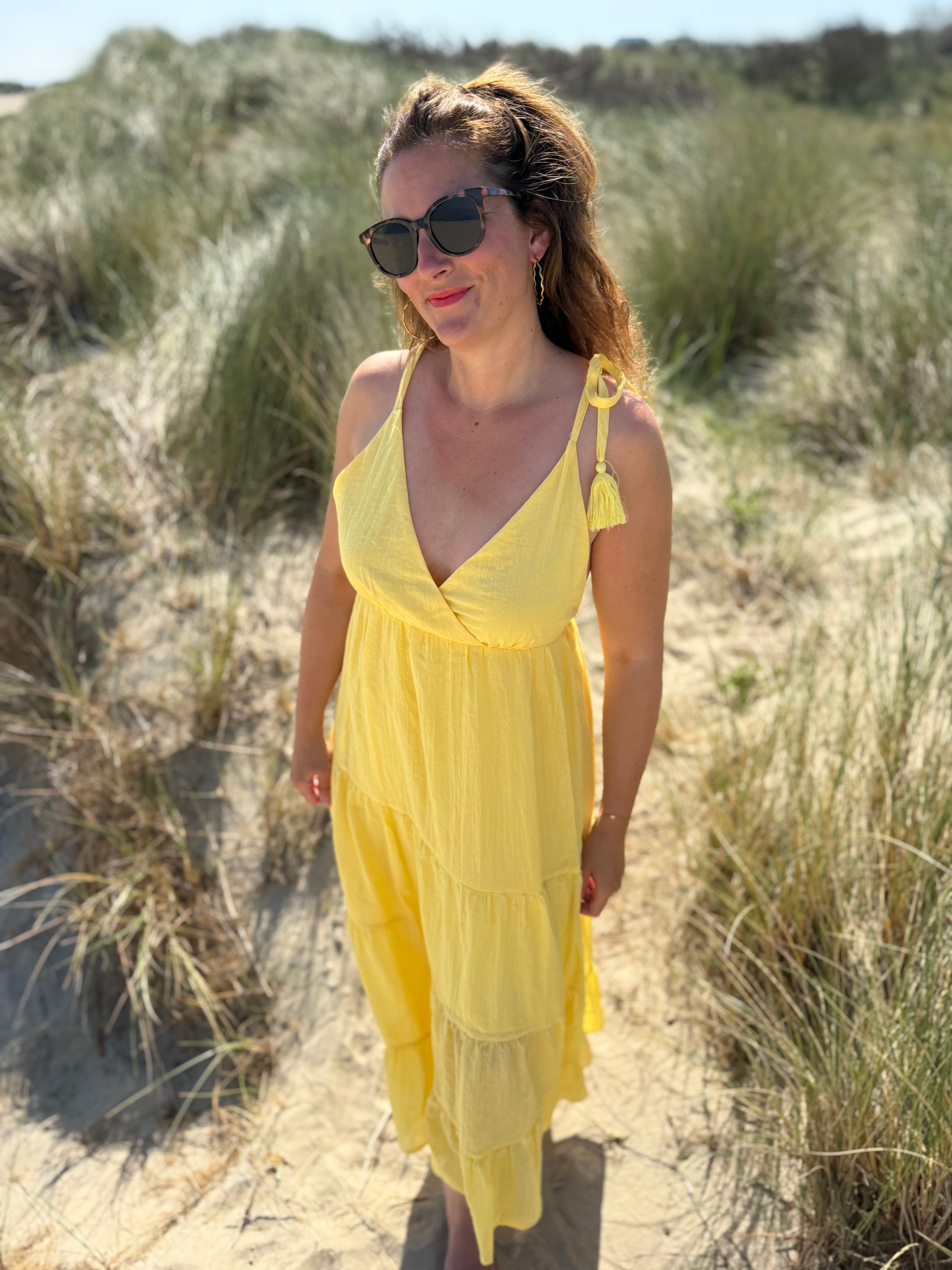 Langes leichtes Maxikleid in strahlendem gelb. Das Kleid hat einen V Ausschnitt und Spaghettiträger zum binden. 