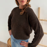 Strickpullover in braun mit Rundhalsausschnitt. Hinten wird der Pulli von Schleifen im Leoprint Muster zusammengehalten.