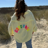 Musselinbluse im lockeren Oversize Look mit langen Ärmeln. Eyecatcher ist ein bunter GOOD VIBES Aufdruck am Rücken. Die Bluse ist in butter yellow