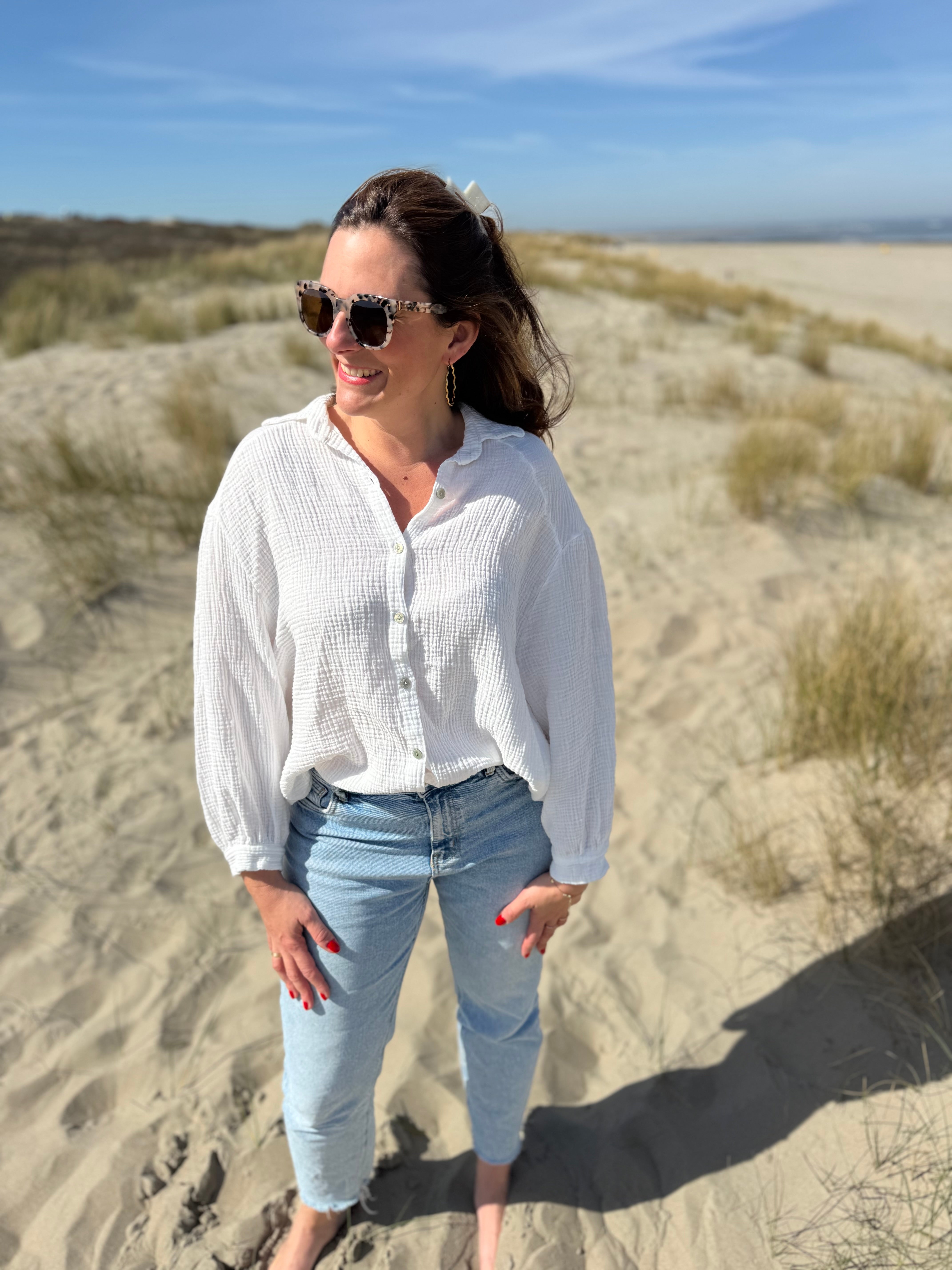 Musselinbluse im lockeren Oversize Look mit langen Ärmeln. Eyecatcher ist ein bunter GOOD VIBES Aufdruck am Rücken. Die Bluse ist weiß.