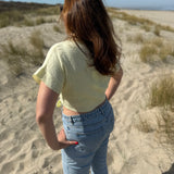 Musselinbluse in cropped Schnitt zum binden. Die Bluse hat kurze Flügelärmel und ist butter yellow.