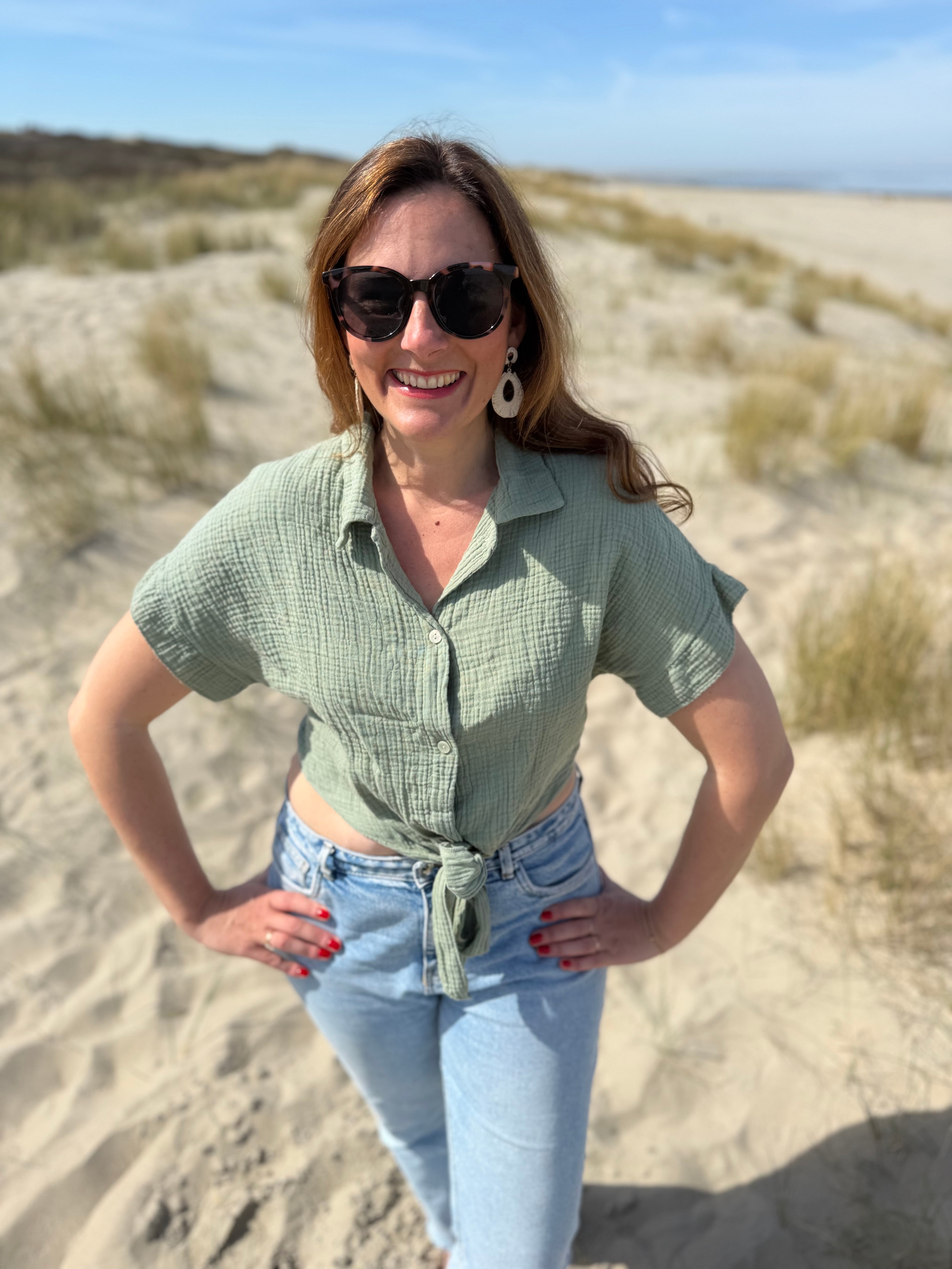 Musselinbluse in cropped Schnitt zum binden. Die Bluse hat kurze Flügelärmel und ist salbei grün.